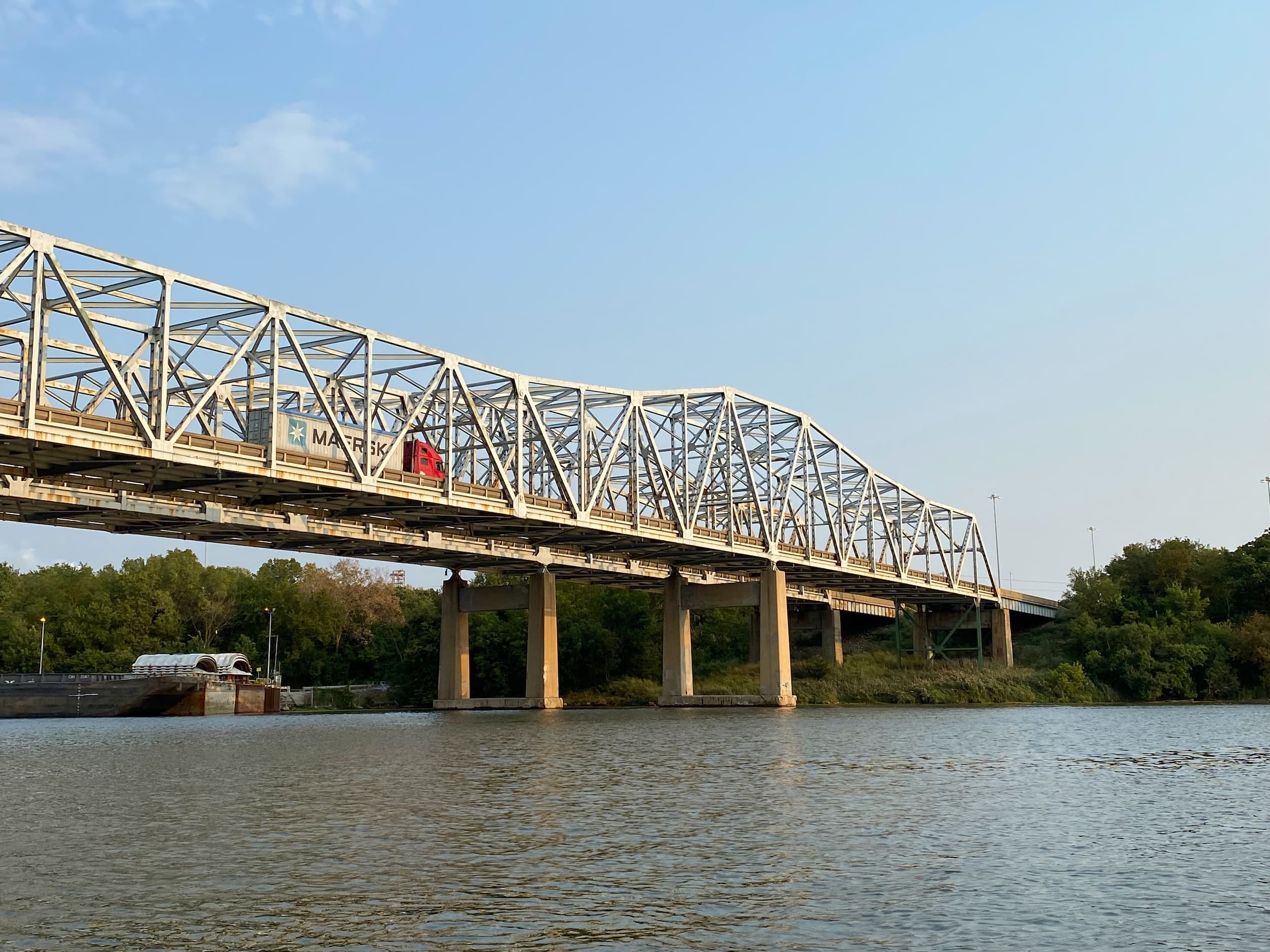 Truck driving along a bridge that is over water